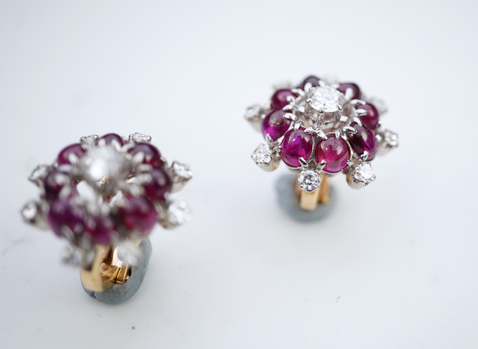 A pair of ruby and diamond ear clips, mid 20th century